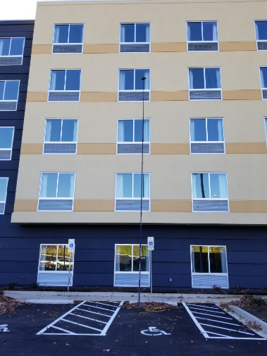 Multi-story residential apartment complex exterior cleaning